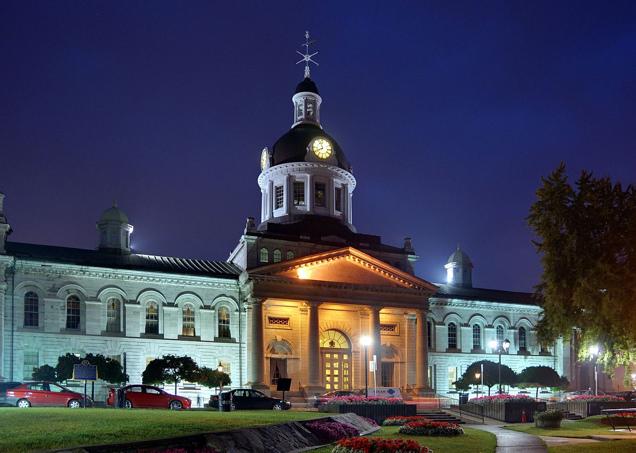 Kingston City Hall with lights on at dusk